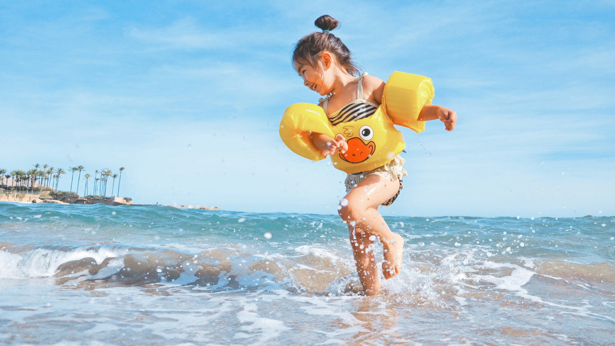 A little girl playing in the surf in Hawaii.