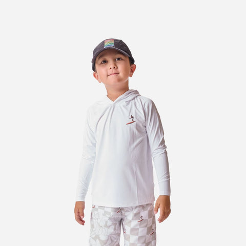 Child wearing a white long-sleeve shirt with a logo and camouflage pants on a white background