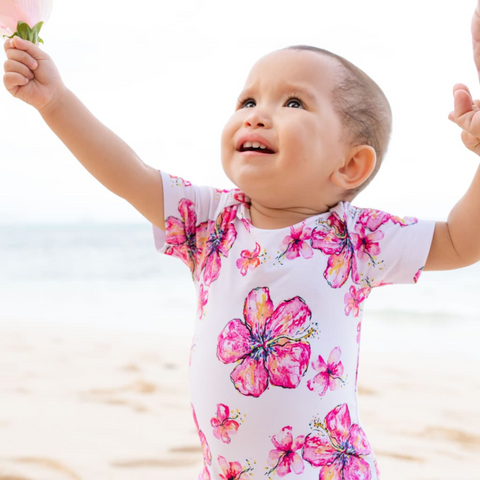 baby in white and pink onesie