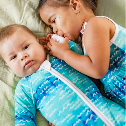 2 kids in blue and white outfits