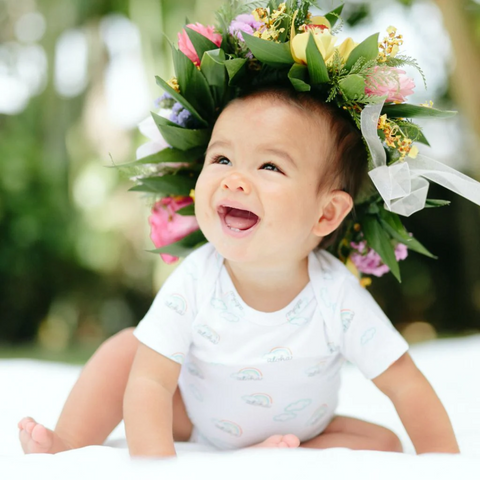 baby with flower crown in coco moon onesie