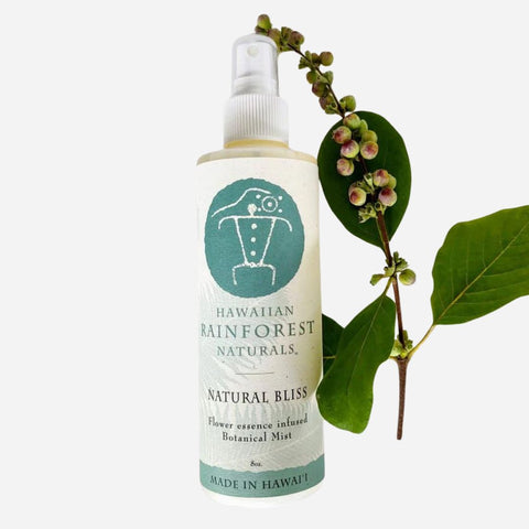 Bottle of Hawaiian Rainforest Naturals product with a branch and leaves on a white background