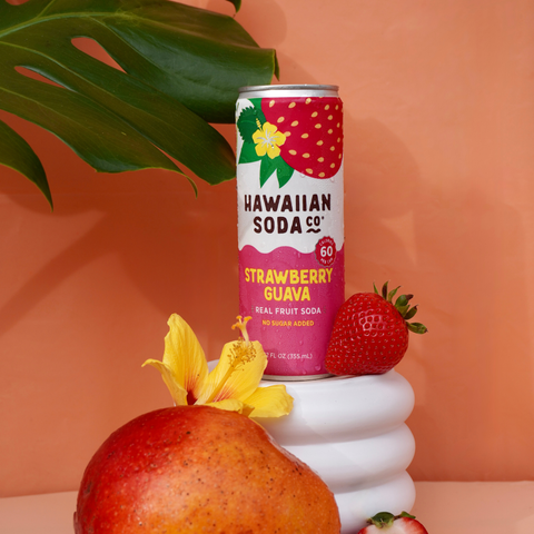 Hawaiian Soda Co. Strawberry Guava can with mango, strawberry, and flower on an orange background