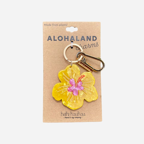 Yellow flower-shaped keychain on a cardboard packaging with 'Alohaland' branding.