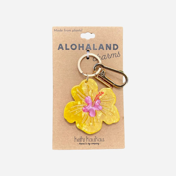 Yellow flower-shaped keychain on a cardboard packaging with 'Alohaland' branding.