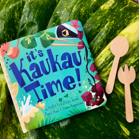 Children's book titled 'it's Kaukau Time!' on a watermelon with wooden spoon and fork.