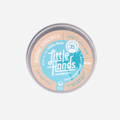 Little Hands sunscreen tin on a light gray background