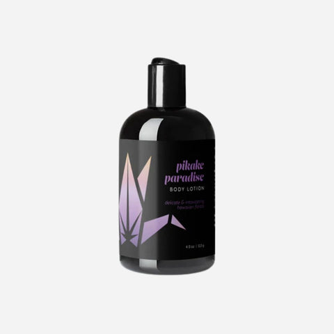 Black bottle of pikake paradise body lotion on a white background