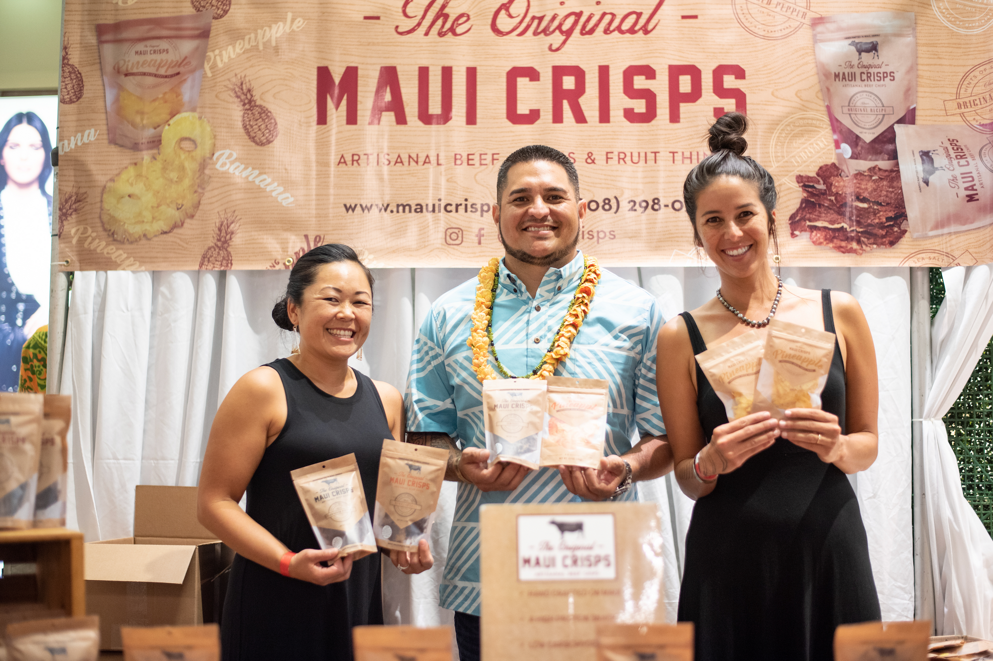 3 people smiling holding up Maui Crisps snack bags