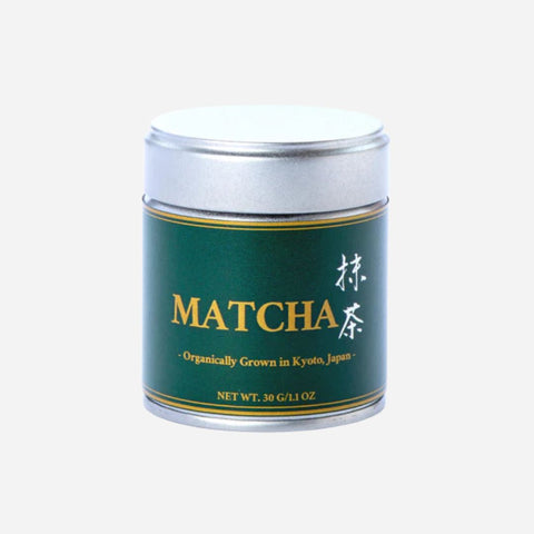 Matcha green tea canister with gold text on a white background