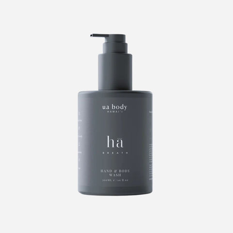 Dark gray bottle of 'ua body Hawaii' hand and body wash on a light gray background