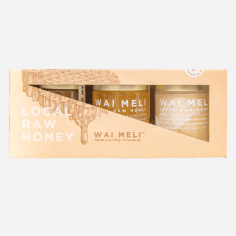 Wai Meli honey jars in a wooden box on a white background