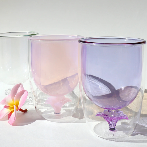 Two gradient glass tumblers with a pink and purple color scheme on a white background.
