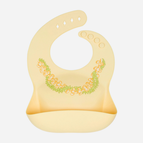 A yellow silicone bib with a floral lei pattern at the front.