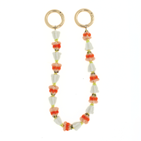 Purse lei with white and orange beads on a white background