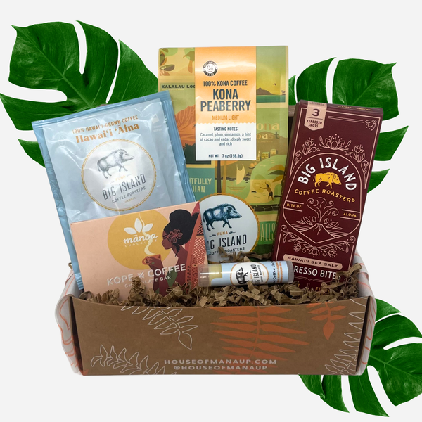 Collection of Big Island Coffee Roasters products in a box with green leaves in the background