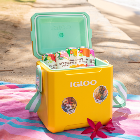 Yellow Igloo cooler with Hawaiian soda cans on a beach setting
