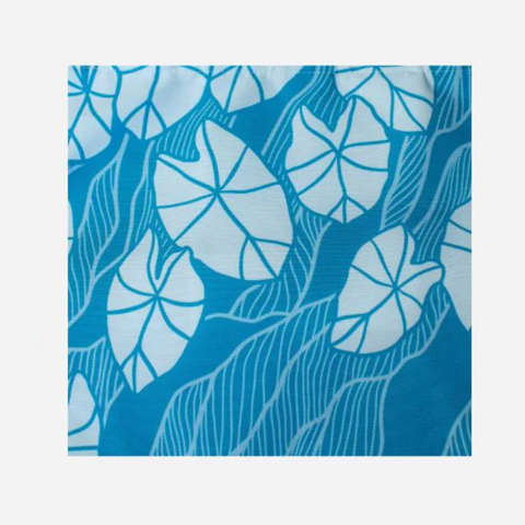 Blue fabric with white leaf pattern on a white background