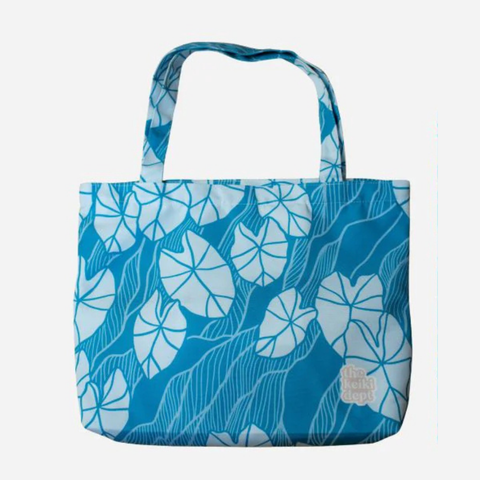 Blue tote bag with white floral pattern on a white background