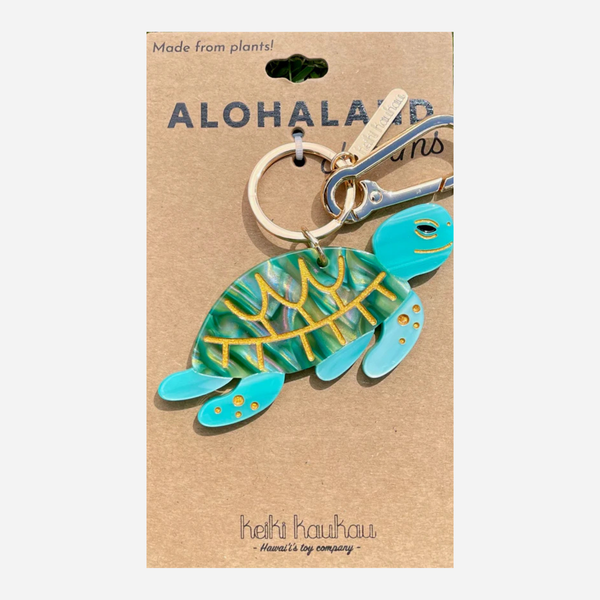 Turtle-shaped keychain on a brown card with 'Aloha Land' branding