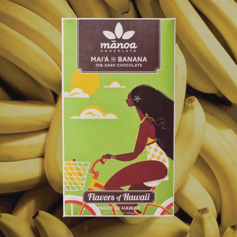 Manoa chocolate bar packaging with a woman and banana illustration, surrounded by bananas.