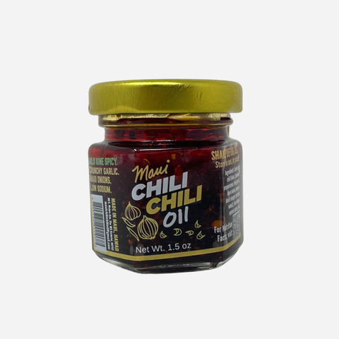Jar of Maui Chili Chili Oil with a gold lid on a white background