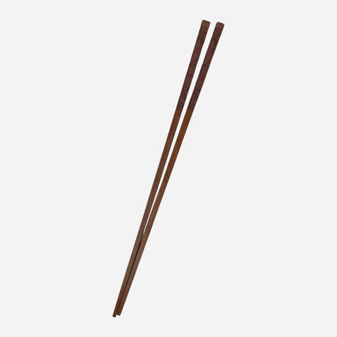 Pair of wooden chopsticks on a white background
