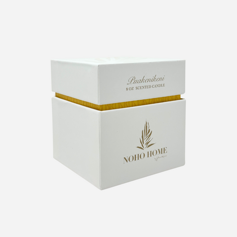 White candle box with gold text and branding on a white background