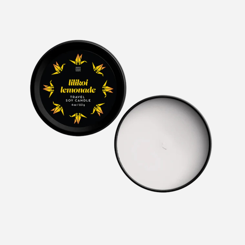 Travel-sized candle in a black tin with 'Lilikoi Lemonade' branding on a white background