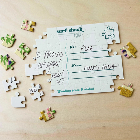 Jigsaw puzzle with personalized message on a wooden surface