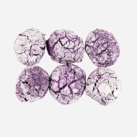 Purple and white crinkled cookies on a white background