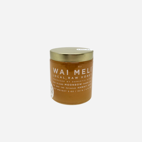 Jar of Wai Meli local raw honey on a white background
