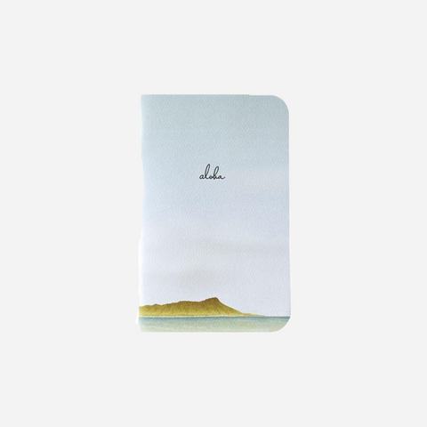 Notebook with a scenic design and 'aloha' text on a white background