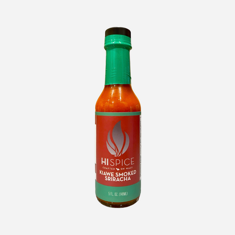 Bottle of Klawe Smoked Sriracha with a green cap and label on a white background
